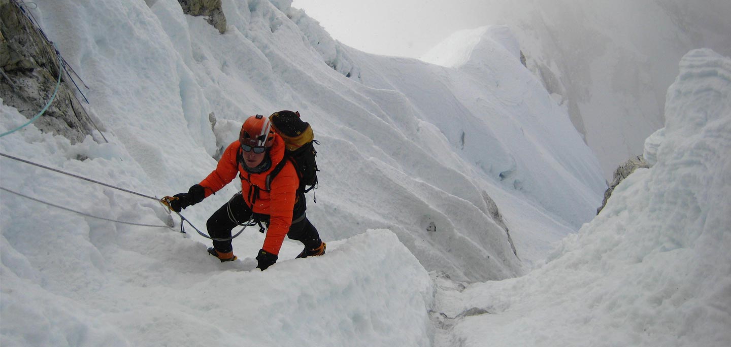 one mountaineer trying to climb mount ama dablam with help of mountain rope leash